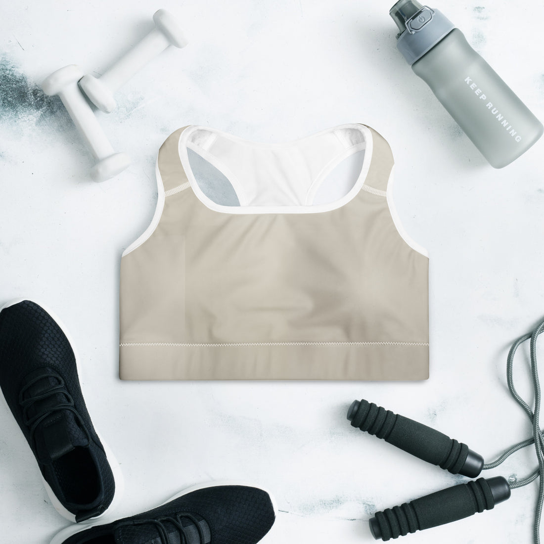 Beige Padded Sports Bra Set Do It for the Plot displayed with workout equipment and sneakers.